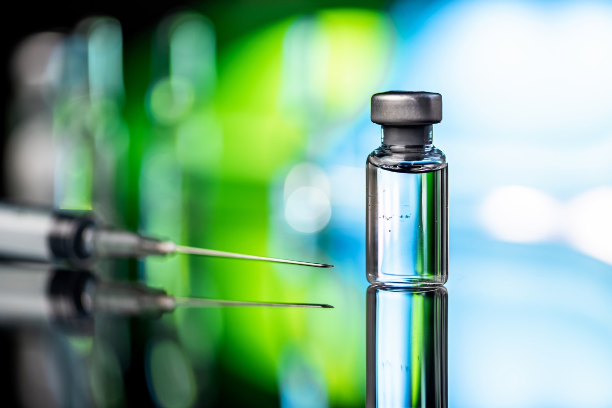 Pharmaceutical vial on a table with syringe